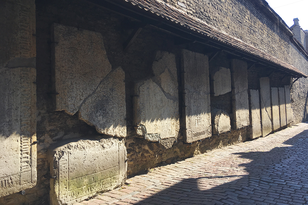 На стенах переулка — могильные плиты бывших захоронений. Почему их там разместили, я так и не поняла. Возможно, для большей атмосферности